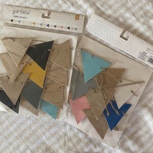 2 packs of multi colored wood triangle garland. New. Party decor.